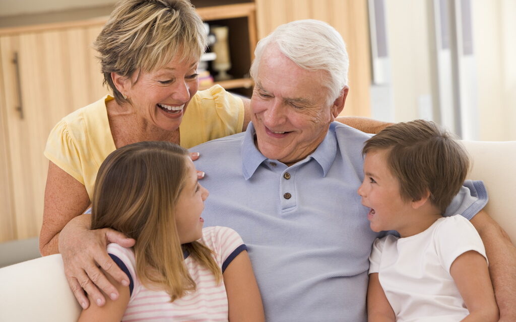 Grandparents laughing with grandchildren